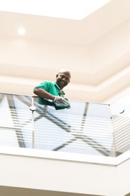 Stathakis day porter wiping down glass railing