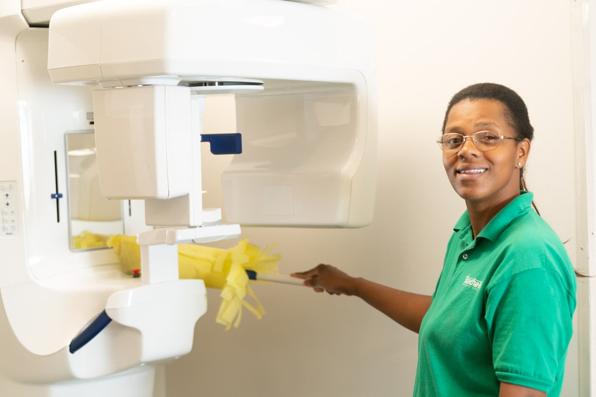 Stathakis employee cleaning medical equipment