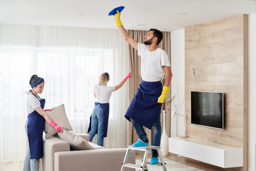 Professional-cleaning-service-team-cleans-living-room-in-modern-apartment